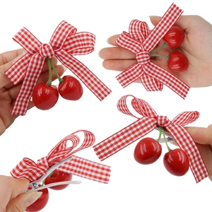 Kids cute cherry bow hair clip with red checkered ribbon and green leaves on white background