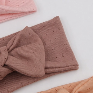 Detail of baby organic cotton headbands showing breathable pointelle knit and bow texture