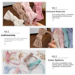 Detailed close-up of handmade ribbed cotton bow headbands in various spring colors