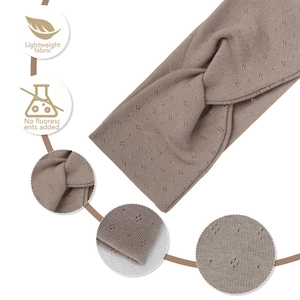 Detail view of brown pointelle knit yoga headband with cross-knot design and soft fabric icons