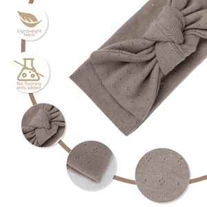 Macro detail of breathable organic cotton baby headband with pointelle bow and soft rib texture
