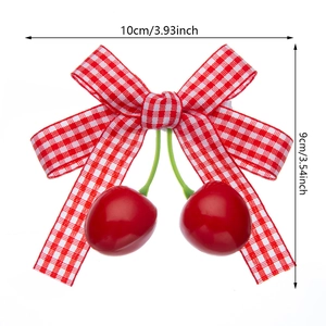 Kids red gingham bow hair clip with cherry charms and size measurements display