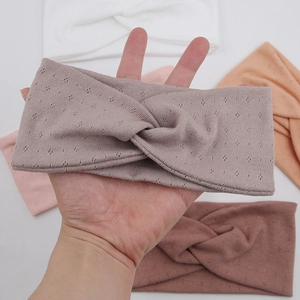 Detail view of cotton yoga headbands with cross-knot design and breathable knit texture