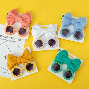 Five-color kids flower sunglasses and bow headband set displayed on yellow background
