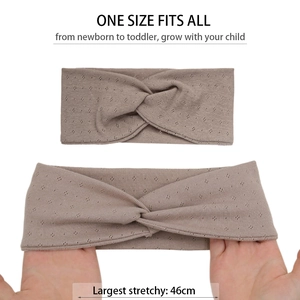 Detail of light brown knitted baby headband showing twist knot and 46cm stretch texture