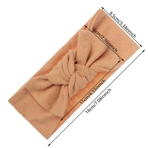 Organic cotton baby headband with large bow in soft peach color for infants