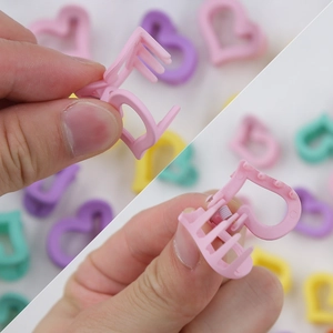 Vue détaillée des mini pinces à cheveux cœur macaron pour enfants avec ressort et dents