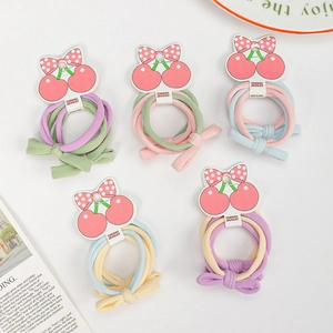 Vue détaillée des élastiques à cheveux de couleur macaron avec un joli nœud pour enfants