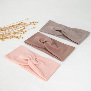 Set of three elastic cross yoga headbands in pink, light coffee, and dark gray knit fabric