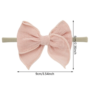 Bandeau bébé rose pastel avec nœud en lin texturé et sangle élastique pour nouveau-né