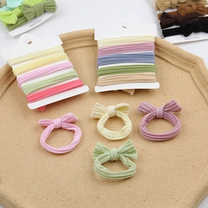 Detailed macro of five high-elasticity bow hair ties in assorted pastel colors