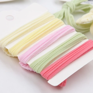 Close-up of colorful velvet elastic hair bands in macaron colors on a white card display