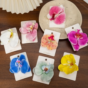 Collection of orchid hair clips in eight vibrant colors with elegant pearl centers