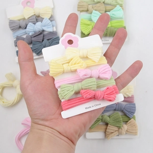 Macro shot of macaron color bow headbands in soft ribbed knit fabric for infants
