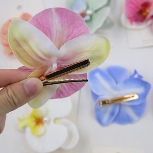 Realistic orchid flower hair clip in multiple colors for a bohemian seaside vacation style