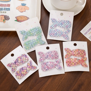 Detail of colorful sequined mermaid tail hair clips on a decorative card display