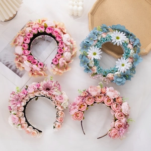Detailed macro view of artificial silk flower headbands in rose and daisy styles