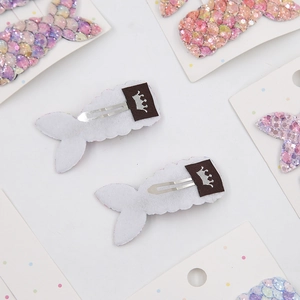 Detail of mermaid tail hair clip showing colorful sequins and silver metal duckbill clip
