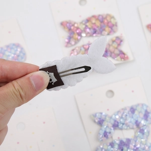 Close-up of sequined mermaid tail hair clip with felt backing and metal duckbill clip