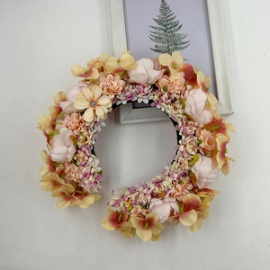 Close-up of colorful faux flowers on a floral headband with cream, pink and purple petals