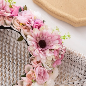 Close-up of pink and white fabric roses and daisies on a Bohemian style floral headband