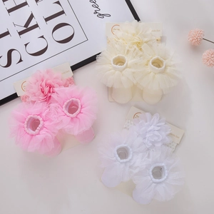 Detail of infant chiffon headband and lace socks set in pink, beige, and white colors