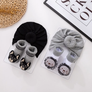 Detail view of cotton baby turban hats and soft animal character socks set in two colors