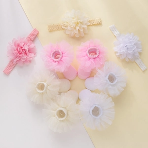 Flat lay of baby chiffon flower headbands and matching lace socks in three soft colors