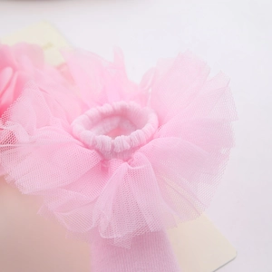 Detail of pink chiffon flower on baby headband with soft layered mesh texture