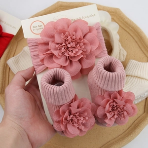 Detail view of baby chiffon flower headband and socks set in dusty rose knit fabric