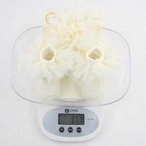 Infant cream chiffon ruffle socks set with decorative flower for baby photography