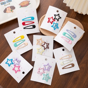 Close-up of colorful star and teardrop hair clips set on a decorative card
