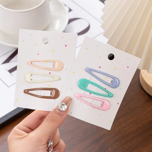 Close-up of matte star and teardrop hair clips set in earthy and macaron tones