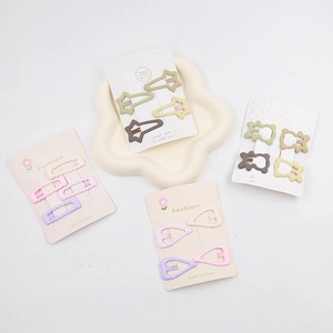 Close-up of star and bear shaped hair clips in macaron colors on display cards