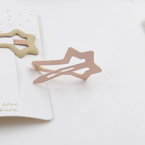 Pink and yellow hollow star metal hair clips on a white card display set