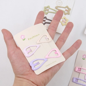 Set of four heart-shaped matte metal BB hair clips in assorted Morandi pastel colors