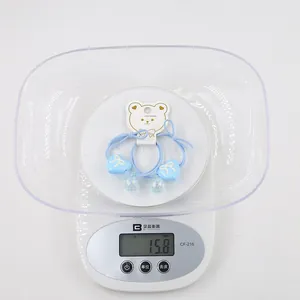 Sky blue heart hair ties with glitter charms on white bear card weighing 15.8g