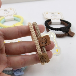 Detail of high elastic woven hair ties with smile leather patch in Morandi colors