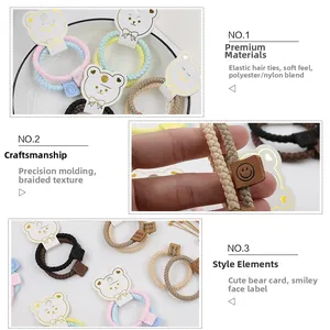 Detail of colorful braided elastic hair ties with handmade leather smiley face tags