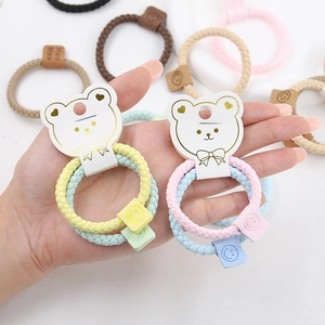 Set of two elastic braided hair ties for kids with smiley face charms and bear card packing