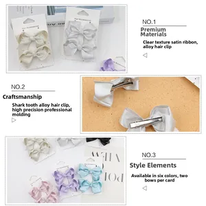Detail of satin bow hair clips with alloy alligator grip and ribbed ribbon texture