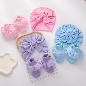 Newborn cotton turban hat and lace trim socks set with large bow detail for baby girls