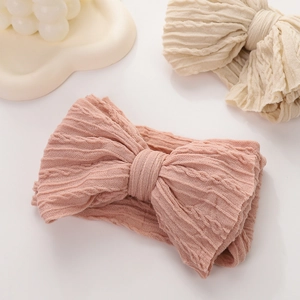 Detail of baby headband with jacquard bow design and soft ribbed knit texture