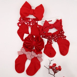 Detail of red baby headband and socks set with polka dots and heart patterns
