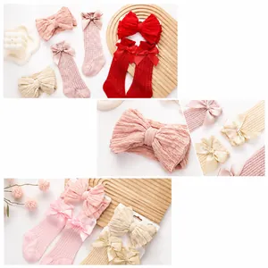 Detail view of baby headband and socks set featuring hollow mesh texture and large bows
