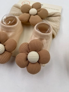 Detail van baby haarband en sokkenset met 3D-bloemen met bruin gestreepte bloemblaadjes