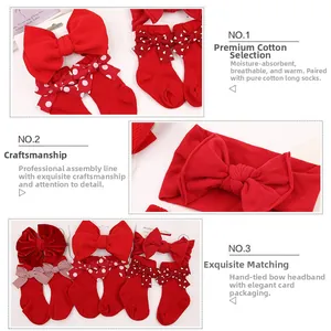 Detail of red baby headband and ribbed cotton socks set with decorative bow accents