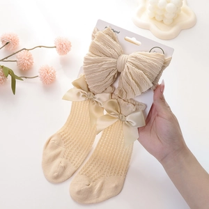 Infant headwrap and hollow mesh socks set with large bows in creamy beige cotton