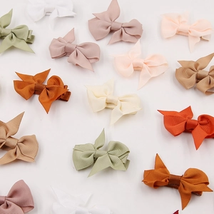 Colorful set of ribbed ribbon bow hair clips for baby girls on a white background