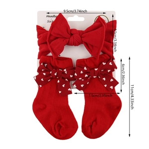 Red infant headband and heart print socks gift set with a large knit bow ornament